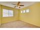 Bright bedroom with plush carpeting, a ceiling fan, and large windows with horizontal blinds at 6086 Shadow Oak Dr, North Las Vegas, NV 89031