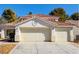 Charming two-story home featuring a three-car garage, tiled roof, and manicured landscaping at 6086 Shadow Oak Dr, North Las Vegas, NV 89031