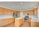 Well-lit kitchen featuring an island, stainless steel appliances, and white countertops at 6086 Shadow Oak Dr, North Las Vegas, NV 89031