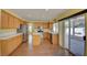 Open kitchen featuring wood cabinets, stainless steel appliances, and sliding doors to patio at 6086 Shadow Oak Dr, North Las Vegas, NV 89031