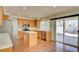 Bright kitchen with stainless steel appliances, center island, and sliding glass doors at 6086 Shadow Oak Dr, North Las Vegas, NV 89031