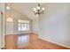 Bright living room features vaulted ceilings, wood floors, and updated chandelier at 6086 Shadow Oak Dr, North Las Vegas, NV 89031