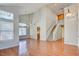 Open-concept living room with vaulted ceiling and staircase with wood flooring at 6086 Shadow Oak Dr, North Las Vegas, NV 89031