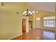 Bright living room with wood floors, chandelier, and stairs to the second floor at 6086 Shadow Oak Dr, North Las Vegas, NV 89031