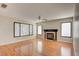 Spacious living room with a fireplace, wood floors, and abundant natural light at 6086 Shadow Oak Dr, North Las Vegas, NV 89031