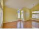 Bright Living room with wood floors, large windows, and vaulted ceiling at 6086 Shadow Oak Dr, North Las Vegas, NV 89031