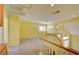 Upstairs loft area featuring a staircase and views of the home's architecture at 6086 Shadow Oak Dr, North Las Vegas, NV 89031