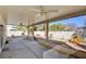 Covered backyard patio with ceiling fans and patio area with lush desert landscaping at 6086 Shadow Oak Dr, North Las Vegas, NV 89031