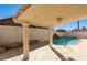 Inviting backyard pool with a covered patio and rock waterfall feature at 6425 Mountain Mesa Ave, Las Vegas, NV 89156