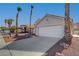 Single story house with a two-car garage and palm trees at 6425 Mountain Mesa Ave, Las Vegas, NV 89156