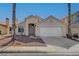 Single-story house with a two-car garage and desert landscaping at 6425 Mountain Mesa Ave, Las Vegas, NV 89156