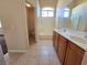 Full bathroom with double sinks, bathtub, and tiled floor at 6448 Elwood Mead Ave # 103, Las Vegas, NV 89156