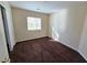 This bedroom features neutral walls, carpet, a window, and closet space at 6448 Elwood Mead Ave # 103, Las Vegas, NV 89156