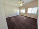 This bedroom features a ceiling fan and bright, natural light from the two large windows at 6448 Elwood Mead Ave # 103, Las Vegas, NV 89156