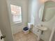 Half bath with pedestal sink and window at 6448 Elwood Mead Ave # 103, Las Vegas, NV 89156