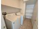 This laundry room includes a washer, dryer, and shelving for organized storage at 6448 Elwood Mead Ave # 103, Las Vegas, NV 89156