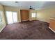 Living room features include carpet, ceiling fan, and access to sliding glass doors at 6448 Elwood Mead Ave # 103, Las Vegas, NV 89156