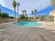 This community pool is surrounded by tall palm trees at 6448 Elwood Mead Ave # 103, Las Vegas, NV 89156