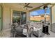 Outdoor patio with seating, a fire pit, heat lamp, and sliding glass doors at 6544 Sandero Springs St, Las Vegas, NV 89166