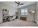 Bedroom with a desk, shelves, a ceiling fan, and a floor lamp at 6544 Sandero Springs St, Las Vegas, NV 89166