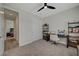 Bedroom with a desk, shelves, a ceiling fan, and a hallway view at 6544 Sandero Springs St, Las Vegas, NV 89166