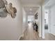 Bright hallway featuring wood-look tile floors, neutral walls, and modern decorative accents at 6544 Sandero Springs St, Las Vegas, NV 89166