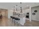 Modern kitchen featuring stainless steel appliances, granite countertops, and four island chairs at 6544 Sandero Springs St, Las Vegas, NV 89166