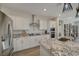 Modern kitchen featuring granite countertops, stainless steel appliances, and a stylish vent hood at 6544 Sandero Springs St, Las Vegas, NV 89166