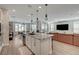 Open kitchen with granite countertops, stainless steel appliances, and seamless flow into the living area at 6544 Sandero Springs St, Las Vegas, NV 89166