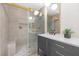 This newly remodeled bathroom features a glass shower with a bench and modern fixtures at 6961 Emerald Springs Ln, Las Vegas, NV 89113