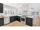 Modern kitchen with black cabinets, stainless steel appliances, and white countertops at 6961 Emerald Springs Ln, Las Vegas, NV 89113