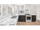 Modern kitchen with black cabinets, stainless steel appliances, and white countertops at 6961 Emerald Springs Ln, Las Vegas, NV 89113