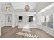 Bright living room with wood floors, open to a modern kitchen and entryway at 6961 Emerald Springs Ln, Las Vegas, NV 89113