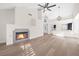 Bright living room with fireplace and wood floors, featuring high ceilings and modern chandelier at 6961 Emerald Springs Ln, Las Vegas, NV 89113