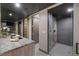 Modern bathroom with a glass-enclosed shower, stone countertop, and sleek fixtures at 709 Dragon Peak Dr, Henderson, NV 89012