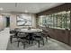 Elegant dining room with a large round table, stylish chairs, and a custom-built wine storage unit at 709 Dragon Peak Dr, Henderson, NV 89012