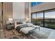 Serene main bedroom featuring soft textures, a seating area, and a sliding glass door that leads to a private patio at 709 Dragon Peak Dr, Henderson, NV 89012