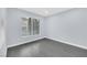 This bedroom features gray wood-look flooring and a large window for natural light at 7135 S Durango Dr # 209, Las Vegas, NV 89113