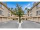 Attractive apartment complex exterior showcasing community parking and mature landscaping and palm trees at 7135 S Durango Dr # 209, Las Vegas, NV 89113