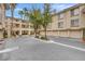 Exterior of a well-kept apartment complex with garages, landscaping and palm trees at 7135 S Durango Dr # 209, Las Vegas, NV 89113