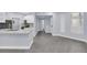 This light-filled living space features sleek gray flooring and leads to the kitchen and hallways at 7135 S Durango Dr # 209, Las Vegas, NV 89113