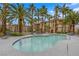 Serene community pool featuring lounge chairs, palm trees, and a relaxing atmosphere for residents to enjoy at 7135 S Durango Dr # 209, Las Vegas, NV 89113