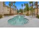 Exterior view of community pool and hot tub area, featuring ample lounge space and palm trees at 7135 S Durango Dr # 209, Las Vegas, NV 89113