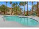 Resort-style pool surrounded by palm trees and lounge chairs, perfect for relaxation and community enjoyment at 7135 S Durango Dr # 209, Las Vegas, NV 89113