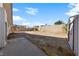 View of the empty backyard with a shed in the corner and a concrete slab patio at 720 Sam Jonas Dr, Las Vegas, NV 89145