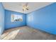 Empty blue bedroom with wall to wall carpet and a window at 720 Sam Jonas Dr, Las Vegas, NV 89145