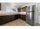 Traditional kitchen features wooden cabinets, a stainless steel refrigerator, and a window over the sink at 720 Sam Jonas Dr, Las Vegas, NV 89145