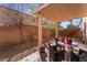 Covered patio in backyard has room for entertaining, desert landscaping, and block wall at 7321 Aspire Ct, Las Vegas, NV 89113