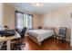 Bedroom featuring wood floors, a work desk, and a comfortable bed, perfect for relaxing at 7321 Aspire Ct, Las Vegas, NV 89113