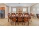 Elegant dining room showcasing a large wood table with ornate chairs and natural light at 7321 Aspire Ct, Las Vegas, NV 89113